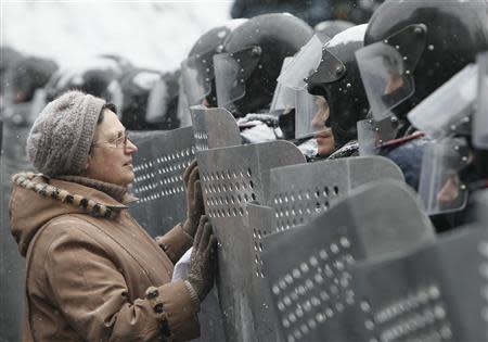 A woman addresses Ukrainian Interior Ministry members who lined up during clashes with pro-European protesters in Kiev