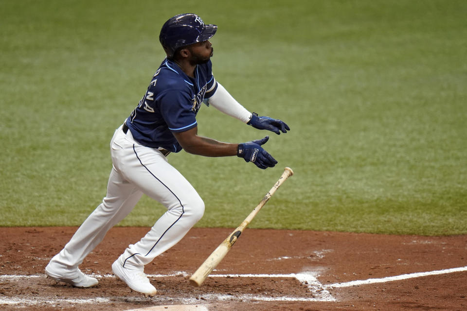 Tampa Bay Rays' Randy Arozarena hits a triple off Toronto Blue Jays pitcher Robbie Ray during the fourth inning of Game 1 of a wild card series playoff baseball game Tuesday, Sept. 29, 2020, in St. Petersburg, Fla. (AP Photo/Chris O'Meara)