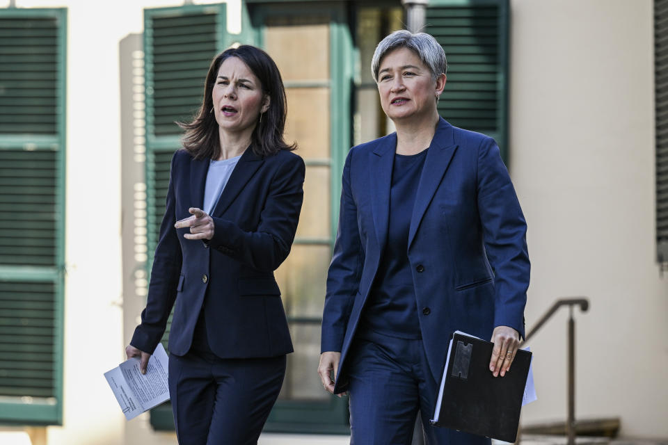 Germany's Foreign Minister Annalena Baerbock, left, and Australian Foreign Minister Penny Wong arrive for a news conference in Adelaide, Friday, May 3, 2024. (Michael Errey/Pool Photo via AP)