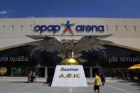 People gather outside OPAP Arena, following overnight clashes between rival supporters in Nea Philadelphia suburb, in Athens, Greece, Tuesday, Aug. 8, 2023. European governing soccer body UEFA says it has postponed a Champions League qualifying game between AEK Athens and Croatia's Dinamo Zagreb scheduled for Tuesday because of the violence. Eight fans were injured while Greek police said Tuesday they had made 88 arrests, mostly of Croatian supporters. (AP Photo/Thanassis Stavrakis)