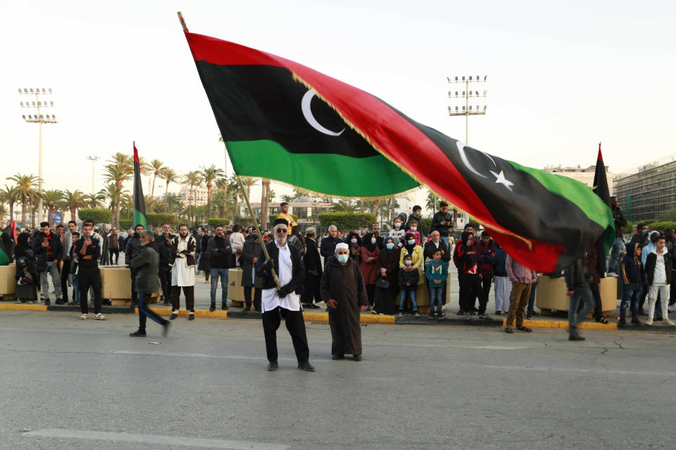 Libyans celebrate the 70th anniversary of their country's independence, despite widespread disappointment over the postponement of the presidential elections, which were scheduled to take place on the same day, in Martyrs' Square, Tripoli, Libya, Friday, Dec. 24, 2021. (AP Photo/Yousef Murad)