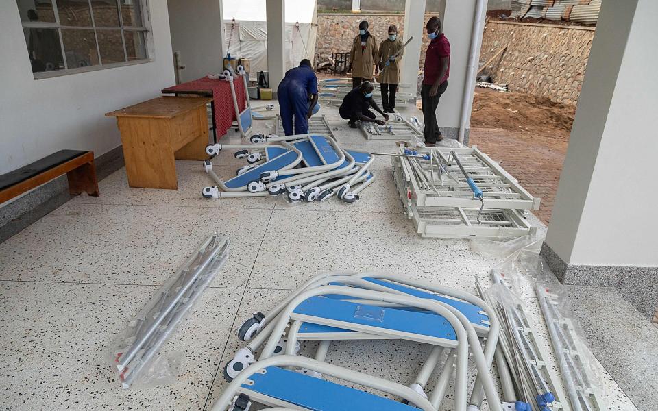 Ugandan Medical staff members assemble beds to be used in the Ebola treatment Isolation Unit at Mubende regional referral hospital in Uganda on September 24, 2022 - BADRU KATUMBA/AFP via Getty Images