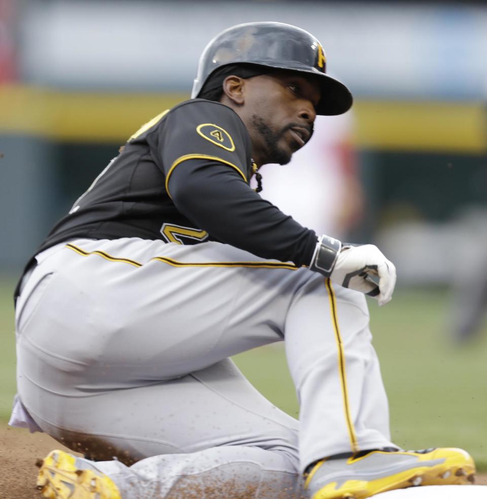 Pittsburgh Pirates' Andrew McCutchen advances to third on a wild pitch by Cincinnati Reds relief pitcher Sam LeCure on Tuesday, April 15, 2014, in the seventh inning of a baseball game that was suspended after six innings Monday evening by rain in Cincinnati. McCutchen scored later in the inning in the game. Pittsburgh won 8-7. (AP Photo/Al Behrman)