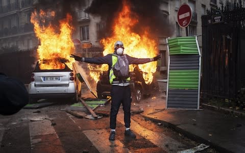Protesters clashes with riot police on Foch avenue next to the Place de l'Etoile, setting cars ablaze during a Yellow Vest protest on December 1, 2018 in Paris, France - Credit: Etienne De Malglaive/Getty Images Contributor