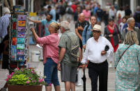 People walk on street in Saint Jean de Luz, southwestern France, Monday, June 20, 2022. Tourism is on the rebound around the world this summer after two years of pandemic restrictions, with museums and flights packed – but the global recovery is hampered by inflation and rising virus infection rates in many regions. (AP Photo/Bob Edme)