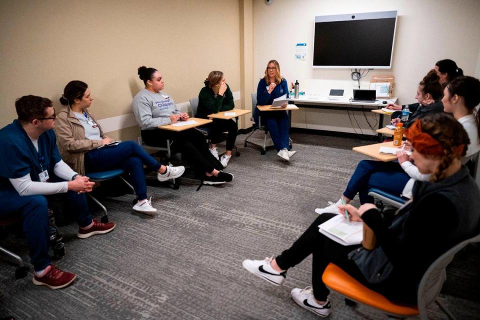 Mary Bridge Children’s hospital RN residents listen to instructions about how they will participate in a simulation lab training where they will treat a “pediatric patient” with seizures and symptoms of abuse as part of MultiCare University’s pediatric nurse residency program at MultiCare University in Puyallup on March 31, 2023.