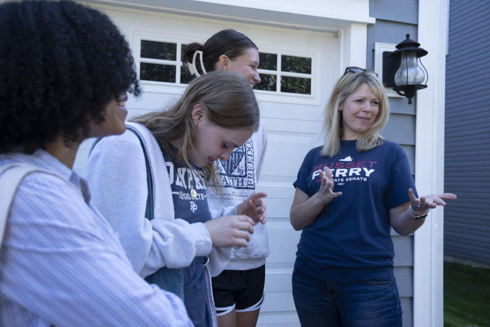 Virginia state Senate candidate Russet Perry, a Democrat, joins campaign volunteers during a campaign stop in the Cascades area of Sterling, Va., Sept. 16, 2023. Perry, a prosecutor and former CIA officer, is running for a seat that could decide control of the Virginia state Senate in November. Saturday, Sept. 16, 2023. (AP Photo/Manuel Balce Ceneta)