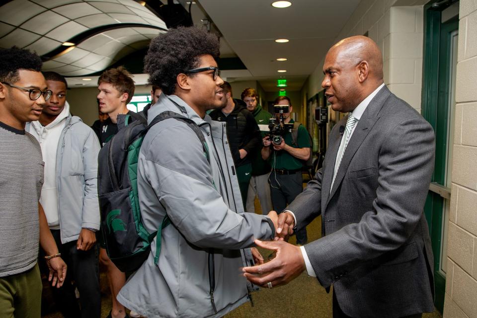 Mel Tucker greets MSU linebacker Antjuan Simmons before Tucker was introduced as MSU's new head football coach on Feb. 12.
