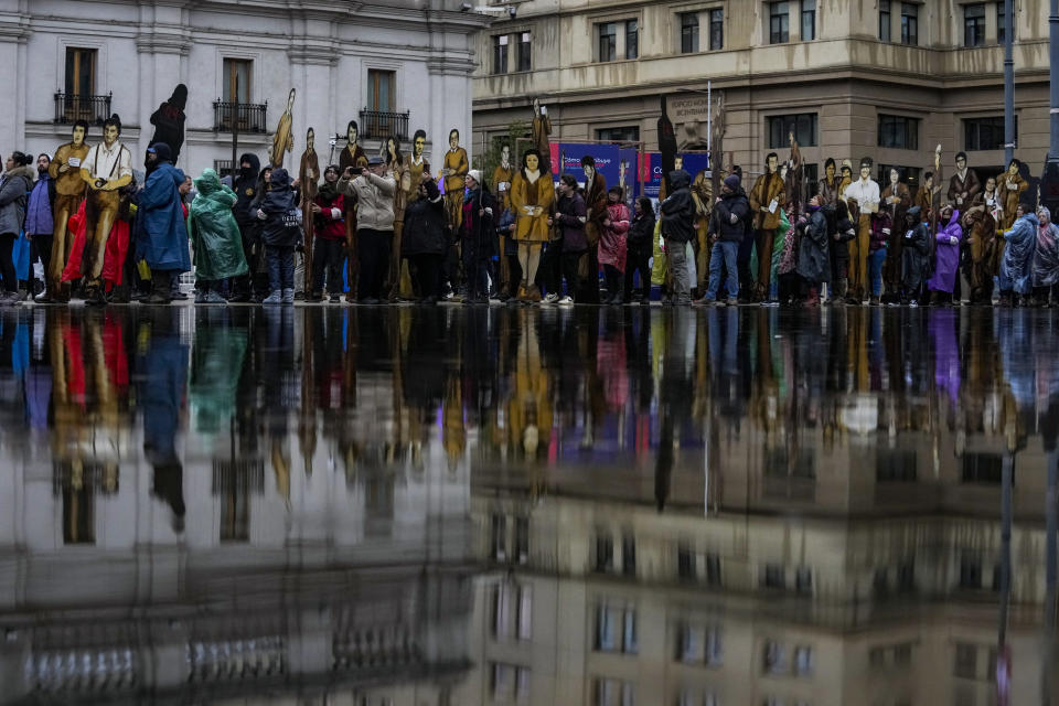 Members of the Disappeared Detainees Relatives Group of Chile hold cardboard cutouts depicting their disappeared relatives in a march commemorating the so-called "Operation Colombo" in which over a hundred dissidents were executed by security forces of Augusto Pinochet's dictatorship, in Santiago, Chile, July 22, 2023. (AP Photo/Esteban Felix)