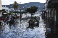 Seawater covers floods a square after an earthquake at the port of Vathi on the eastern Aegean island of Samos, Greece, Friday, Oct. 30, 2020. A strong earthquake struck in the Aegean Sea between the Turkish coast and the Greek island of Samos as the magnitude 6.6 earthquake was centered in the Aegean at a depth of 16.5 kilometers, or 10.3 miles.(AP Photo/Michael Svarnias)