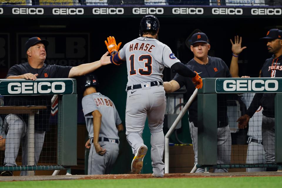 Tigers catcher Eric Haase is congratulated by manager A.J. Hinch, left, and hitting coach Scott Coolbaugh, right, after hitting a home run during the sixth inning on Friday, Sept. 9, 2022, in Kansas City, Missouri.