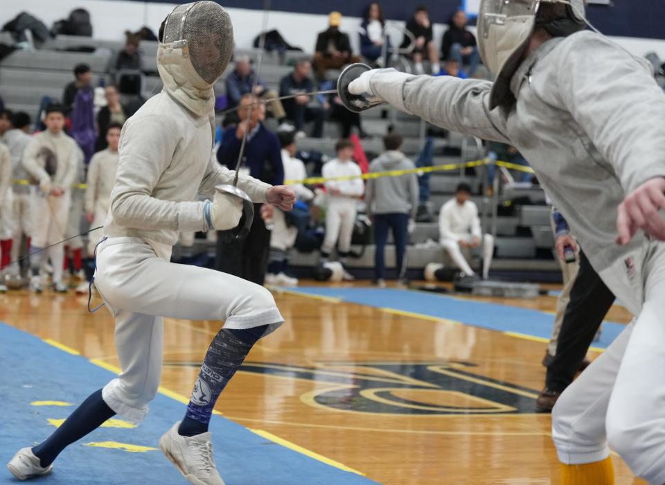 Randolph, NJ -- January 13, 2024 -- Lucas Clymer of Chatham and Sam Masker of Morris Knolls compete at the Morris County Fencing Tournament held at Randolph.