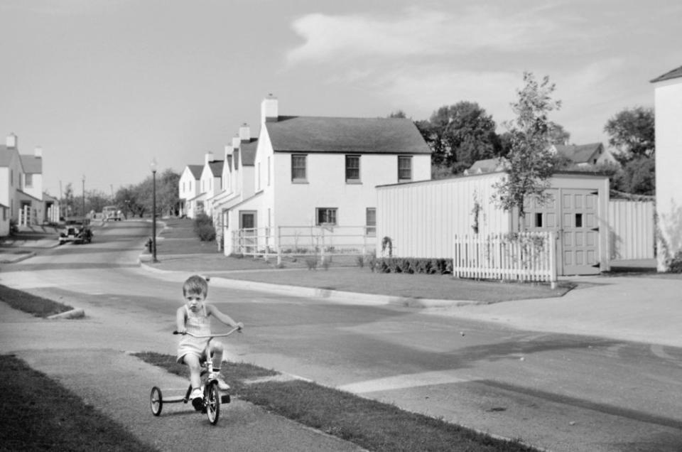 Greendale, Wis., a community constructed by U.S. Department of Agriculture as part of President Franklin Roosevelt's New Deal, in September 1939.<span class="copyright">Universal Images Group via Getty A young boy rides a tricycle in</span>