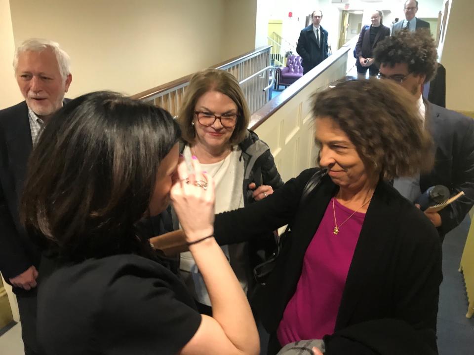 Mendham Township Committeewoman Lauren Spirig wipes a tear and celebrates with fellow Democratic Committeewoman Amalia Duarte after a court challenge to her three-vote victory in the November election was dismissed in Morristown Superior Court