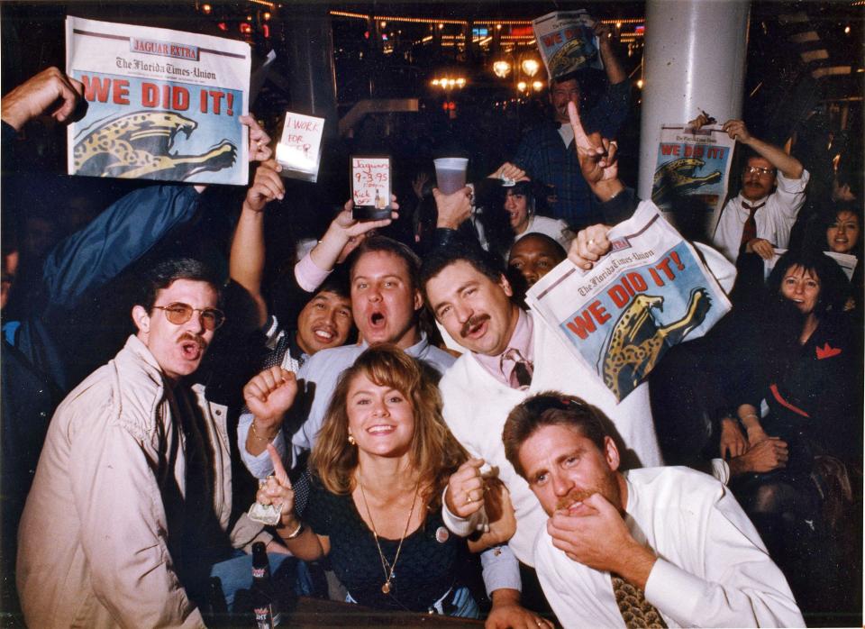 Members of the Jacksonville Jaguars Boosters Club celebrate at the Hooters restaurant and bar at the Jacksonville Landing after the NFL announcement Tuesday that Jacksonville would be an expansion city.