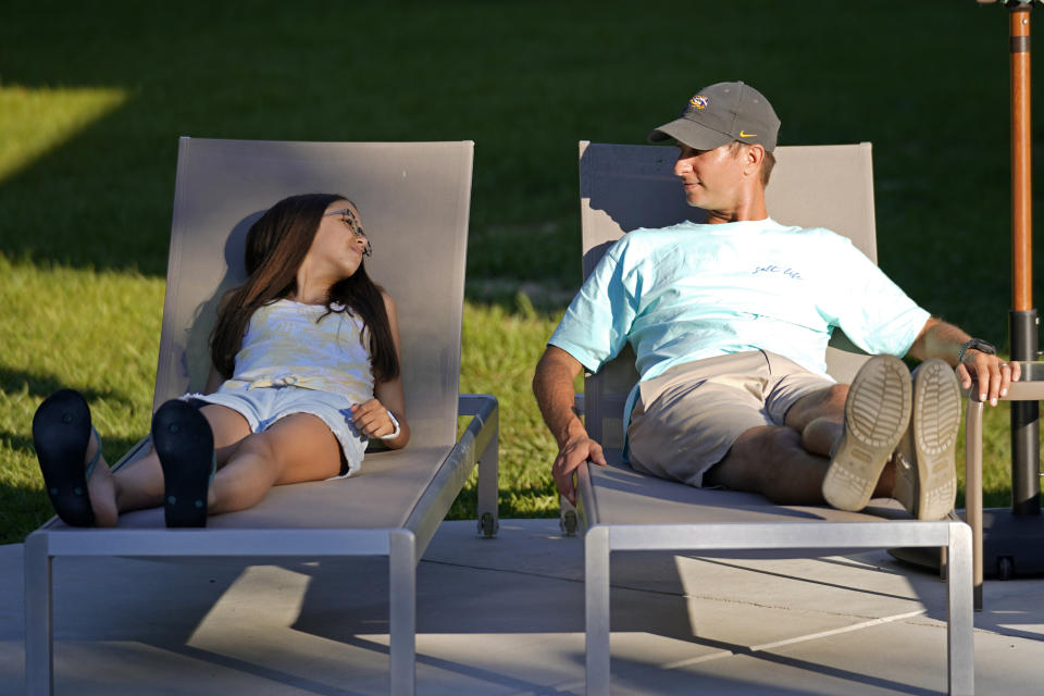 Cecilia Shaffette relaxes in the backyard with her father Rhett Shaffette, at their home in Carriere, Miss., Wednesday, June 16, 2021. The 12-year-old is thriving, eight months after getting a portion of her father's liver. She received the transplant after nearly losing her life to internal bleeding. (AP Photo/Gerald Herbert)