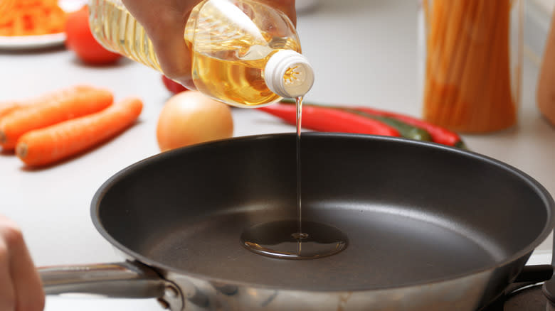 pour oil into skillet