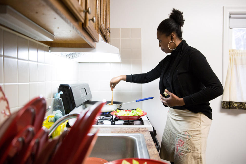 Mona Pompilus prepares an after-work snack in her kitchen in Foxborough. (Photo: Kayana Szymczak for Yahoo News)