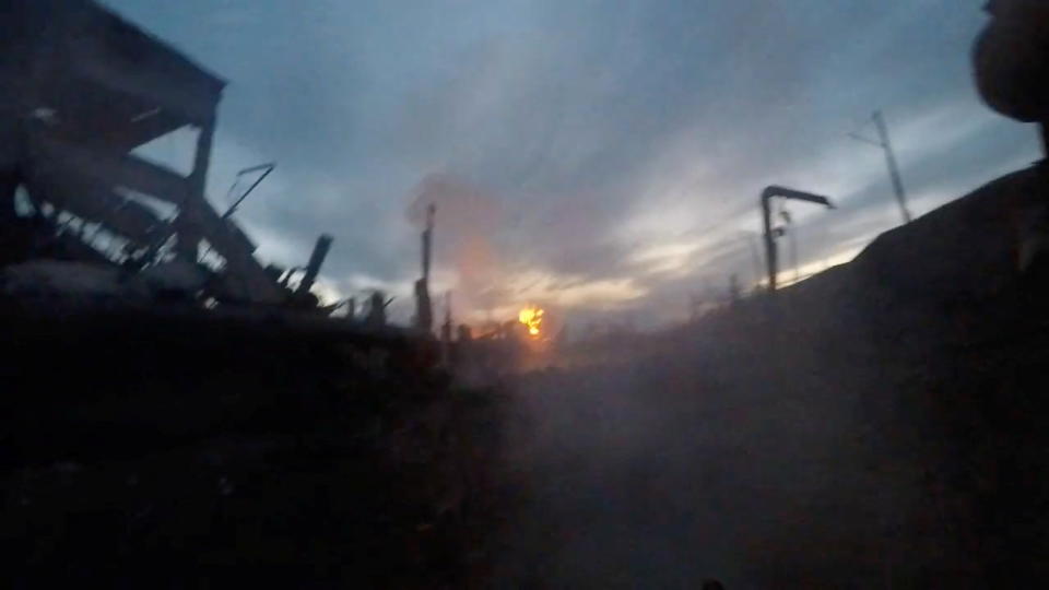 A view of an explosion where munitions impacted after a weapon was fired, amid Russia's invasion of Ukraine, at the Azovstal Iron and Steel Works complex in Mariupol, Ukraine, in this still image taken from a handout video released May 12, 2022. Azov Regiment/Handout via REUTERS THIS IMAGE HAS BEEN SUPPLIED BY A THIRD PARTY. MANDATORY CREDIT