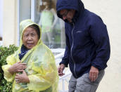 CORRECTS TO SEPT. 3 FROM SEPT. 2- South Beach tourists brave the rain as a tropical storm warning was issued for the Miami Beach, Fla., area on Monday, Sept. 3, 2018. Tropical Storm Gordon lashed South Florida with heavy rains and high winds on Monday, forcing holiday beachgoers to drier ground. (Carl Juste/Miami Herald via AP)