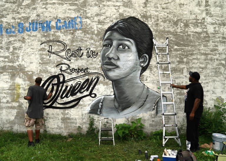 A man paints a mural of the "Queen of Soul" Aretha Franklin near New Bethel Baptist - her father's church - in Detroit, Michigan