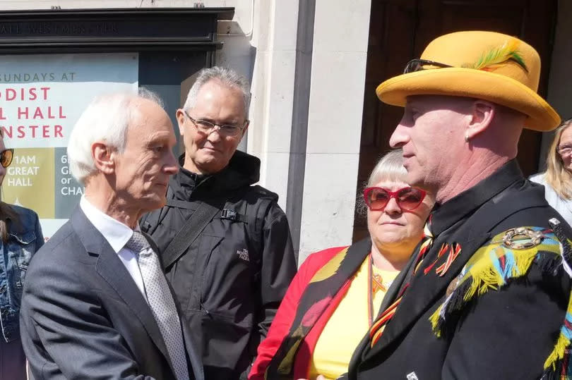 Inquiry report author Sir Brian Langstaff is greeted by campaigners at Westminster yesterday