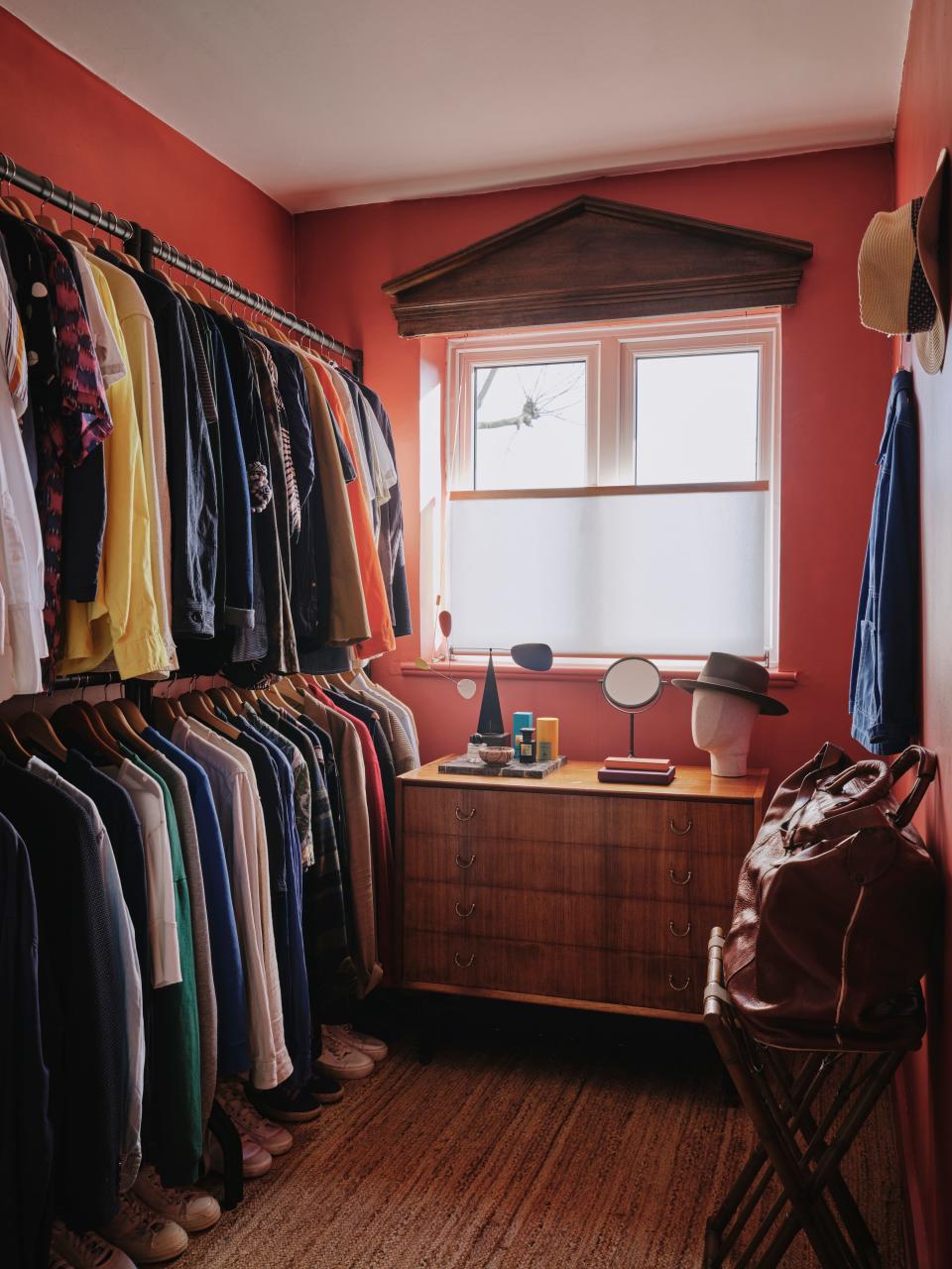 The dressing room, formerly the home’s third bedroom, glows in warm coral.