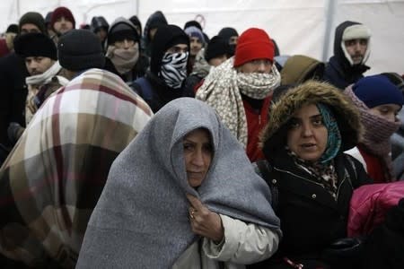 Migrants wait in line inside a registration camp in Presevo, Serbia, January 20, 2016. REUTERS/Marko Djurica