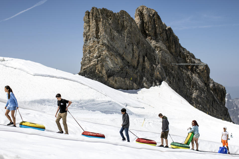 Tourists enjoy the summer temperatures on the Titlis mountain, on Wednesday, June 26, 2019, near Engelberg, Switzerland. All over Europe is hit by a heatwave. (Alexandra Wey/Keystone via AP)