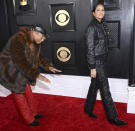 <p>"Happy" singer Pharrell Williams bowed down in a proper tribute to his wife Helen Lasichanh on the red carpet. The couple, who married in 2013, both opted for quilted jackets and pants.</p>