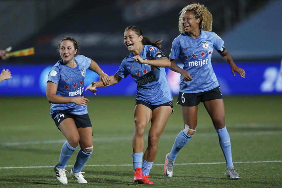 FILE- In this July 18, 2020, file photo, Chicago Red Stars' players Sarah Gordon, center, Casey Short (6) and Danielle Colaprico (24) celebrate their 4-3 win in penalty kicks against the OL Reign in an NWSL Challenge Cup soccer match in Herriman, Utah. Gordon aims to go beyond the social media statements, the T-shirts and the platitudes, and do something to lift up Black lives. The 28-year-old has put her focus on mental health for young women of color in launching her nonprofit organization, HoodSpace. (AP Photo/Rick Bowmer, File)