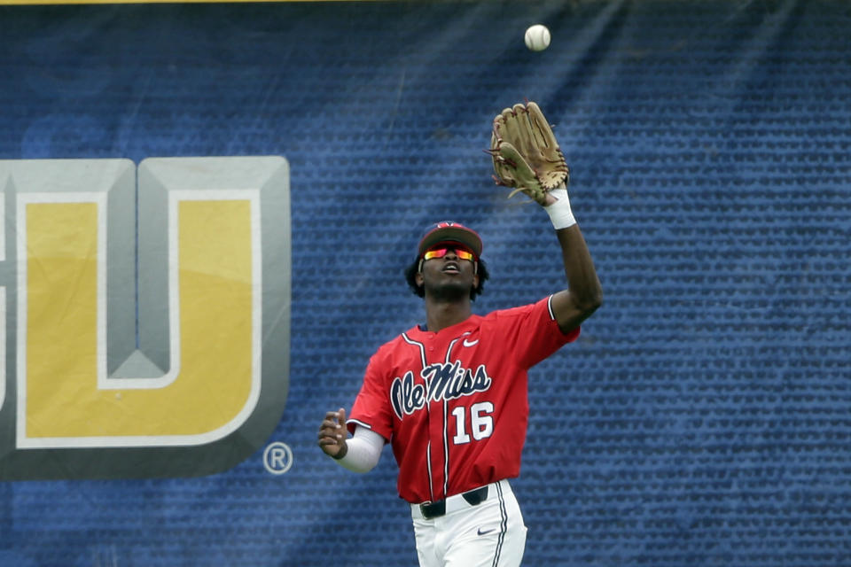 Mississippi outfielder TJ McCants (16) catches a deep fly ball for the out on Vanderbilt's Parker Noland in the second inning of an NCAA college baseball game during the Southeastern Conference tournament Friday, May 28, 2021, in Hoover, Ala. (AP Photo/Butch Dill)