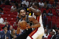 San Antonio Spurs guard Derrick White (4) looks to pass the ball against Miami Heat guard Dion Waiters (11) during the first half of an NBA preseason basketball game, Tuesday, Oct. 8, 2019, in Miami. (AP Photo/Brynn Anderson)