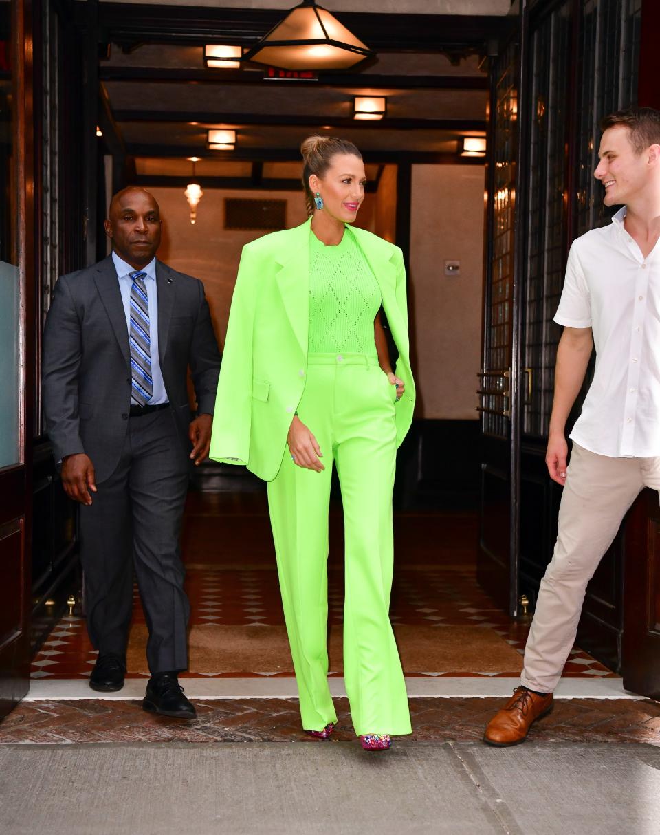 Blake Lively stepped out wearing a monochromatic neon-green suit from the SS'19 Versace menswear collection.