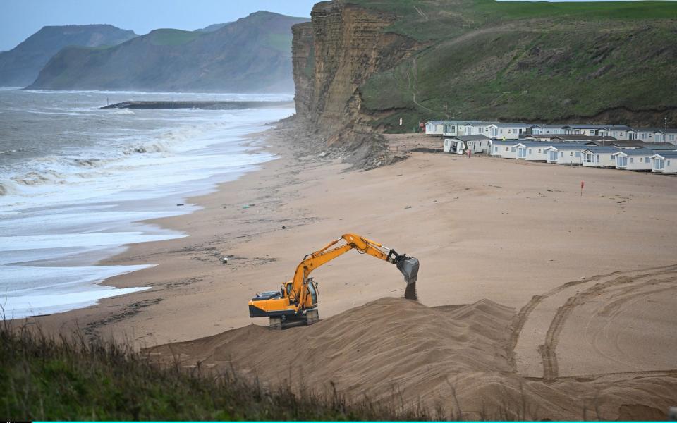 A mechanical digger on the beach in Dorset where Storm Ciaran hit on Thursday