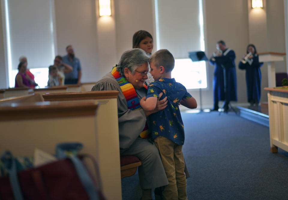 Lucas Watkins tells the Rev. Linda Barnes Popham that he loves Jesus during a service, Sunday, May 21, 2023, in Louisville, Ky. (AP Photo/Jessie Wardarski)