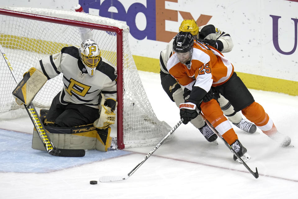 Philadelphia Flyers' James van Riemsdyk (25) can't get a shot off on a wrap around attempt against Pittsburgh Penguins goaltender Casey DeSmith (1) with Dmitry Kulikov (7) defending during the second period of an NHL hockey game in Pittsburgh, Saturday, March 11, 2023. (AP Photo/Gene J. Puskar)