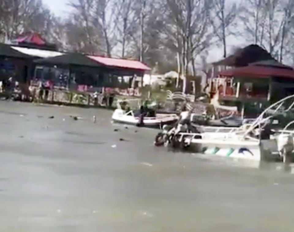 This image taken from video provided by Mohammed Issam shows boats trying to rescue people in the Tigris River after a overloaded ferry sank on Thursday, March 21, 2019 near Mosul, Iraq. Col. Hussam Khalil, head of the Civil Defense in the northern Nineveh province, told The Associated Press the accident occurred as scores of people were out in a tourist area celebrating Nowruz, which marks the Kurdish new year and the arrival of spring. (Mohammed Issam via AP)