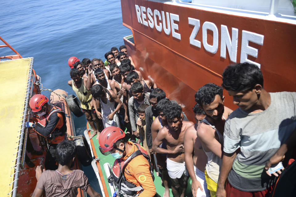 Rohingya refugees board a National Search and Rescue Agency ship after being rescued from their capsized boat in the waters off West Aceh, Indonesia, Thursday, March 21, 2024. A wooden boat carrying dozens of Rohingya Muslims capsized off Indonesia's northernmost coast on Wednesday, according to local fishermen. (AP Photo/Reza Saifullah)