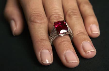 A model wears the "Graff Ruby" a 8.32 carats red hue "pigeon blood" Burmese stone during an auction preview Sotheby's auction house in Geneva, in this November 5, 2014 file photo. REUTERS/Denis Balibouse/Files