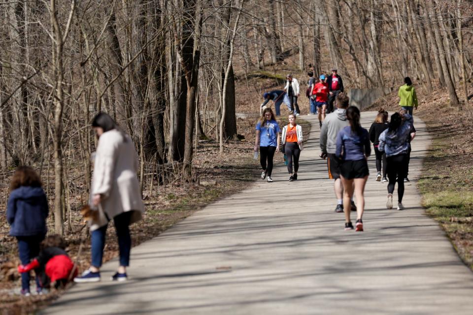 Groups walk along the Wabash Heritage Trail in Happy Hollow Park, Wednesday, March 25, 2020 in West Lafayette.