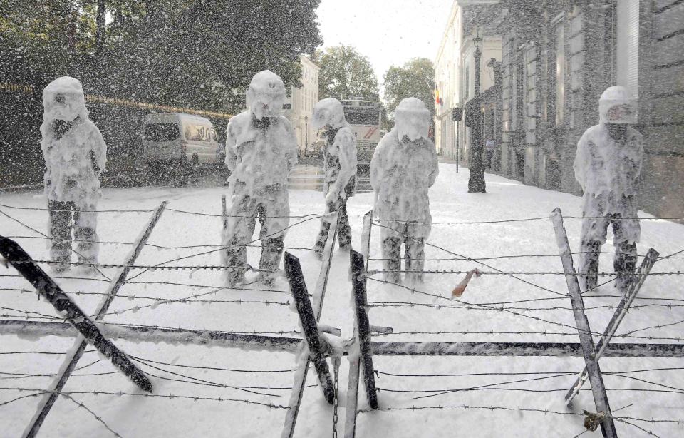 RNPS - PICTURES OF THE YEAR 2013 - Belgian riot police are covered with foam sprayed by Belgian firefighters during a protest for better work conditions in central Brussels October 7, 2013. REUTERS/Yves Herman (BELGIUM - Tags: BUSINESS EMPLOYMENT CIVIL UNREST POLITICS TPX)