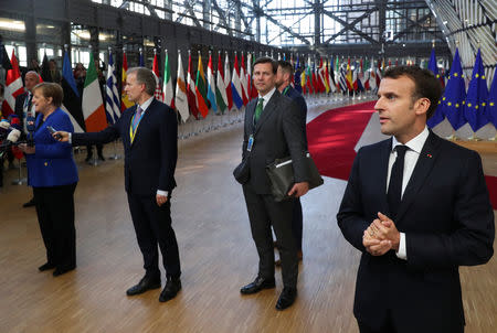 French President Emmanuel Macron and German Chancellor Angela Merkel talk to the media as they arrive at an extraordinary European Union leaders summit to discuss Brexit, in Brussels, Belgium April 10, 2019. REUTERS/Yves Herman