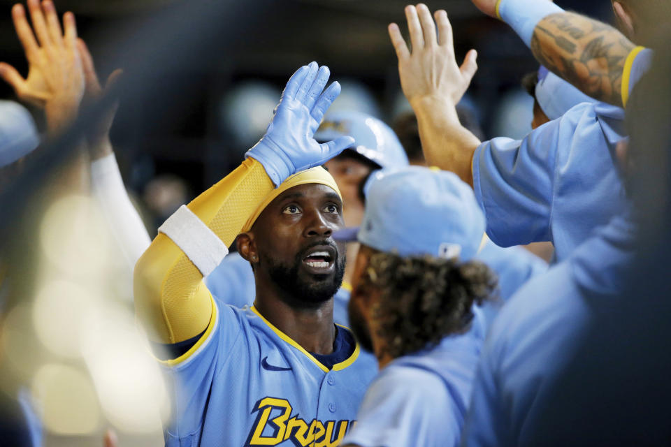 Milwaukee Brewers designated hitter Andrew McCutchen is congratulated by teammates after hitting a two-run home run against the Toronto Blue Jays during the second inning of a baseball game Saturday, June 25, 2022, in Milwaukee. (AP Photo/Jon Durr)