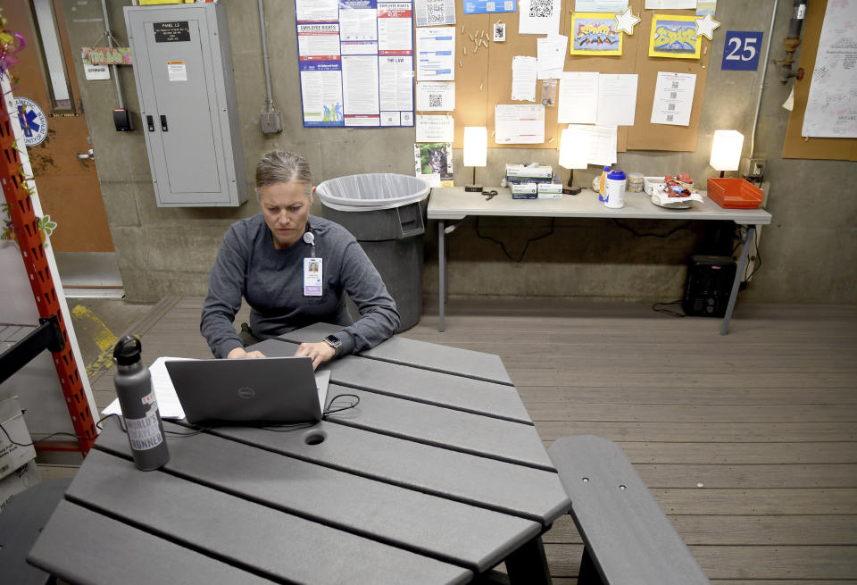 Leigh Foster, who supervises paramedics in Denver's alternative policing program, works at an ambulance bay in the city on Thursday, Oct. 20, 2022. The STAR program uses clinicians and EMTs or paramedics to respond to nonviolent mental health crises, instead of police. Data gathered by The Associated Press show at least 14 of the 20 most populous U.S. cities are hosting or starting such programs, sometimes called civilian, alternative or non-police response teams. They span from New York and Los Angeles to Columbus, Ohio, and Houston, and boast annual budgets that together topped $123 million as of June 2023, the AP found. (AP Photo/Thomas Peipert)