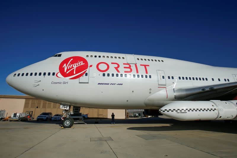 FILE PHOTO: Richard Branson's Virgin Orbit, with a rocket underneath the wing of a modified Boeing 747 jetliner, prior to its takeoff on a key drop test of its high-altitude launch system for satellites from Mojave, California