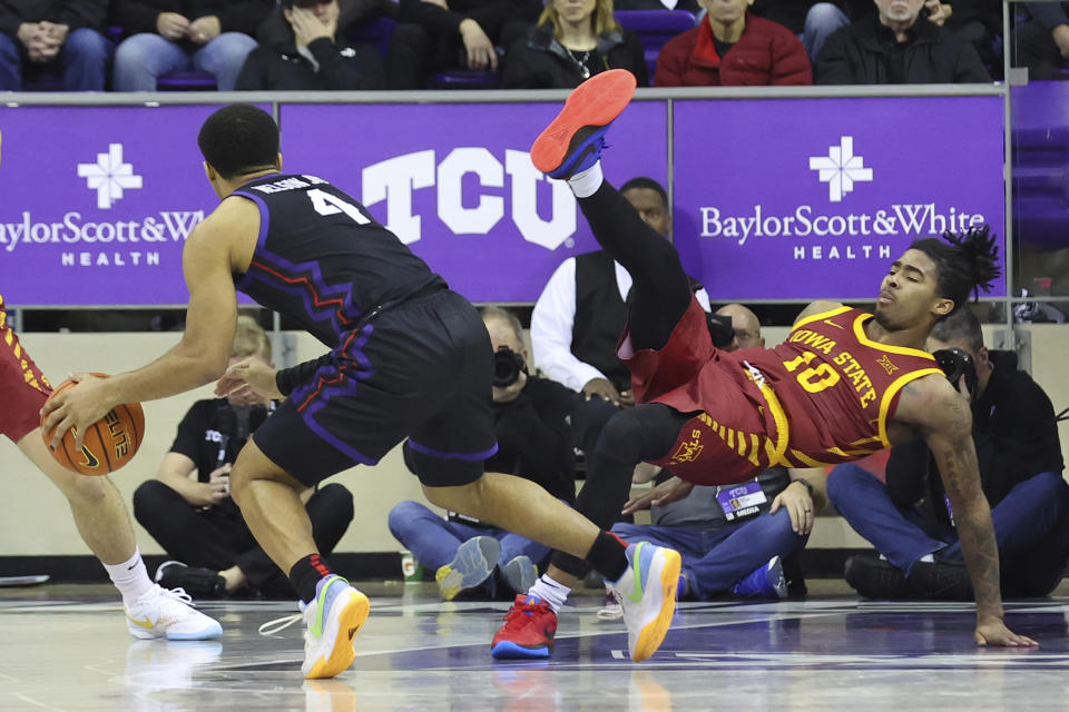 Iowa State guard Keshon Gilbert (10) falls after being fouled by TCU guard Jameer Nelson Jr. (4) in the second half of an NCAA college basketball game Saturday, Jan. 20, 2024, in Fort Worth, Texas. (AP Photo/Richard W. Rodriguez)