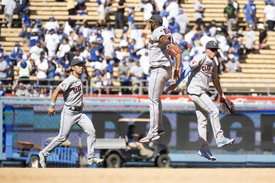 From left, Cleveland Guardians left fielder Steven Kwan, shortstop Amed Rosario, and center fielder Myles Straw celebrate the team's 5-3 win over the Los Angeles Dodgers in a baseball game in Los Angeles, Sunday, June 19, 2022. (AP Photo/Kyusung Gong)