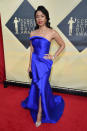 <p>Watson channeled old Hollywood glamour in a blue sateen gown, voluminous hair, and red lip. (Photo: Getty Images) </p>