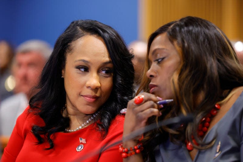 ATLANTA, GA - MARCH 01: Fulton County District Attorney Fani Willis, left and prosecutor Daysha Young, right, speak to each other during a hearing in the case of the State of Georgia v. Donald John Trump at the Fulton County Courthouse on March 1, 2024, in Atlanta, Georgia. - Photo: Alex Slitz-Pool (Getty Images)